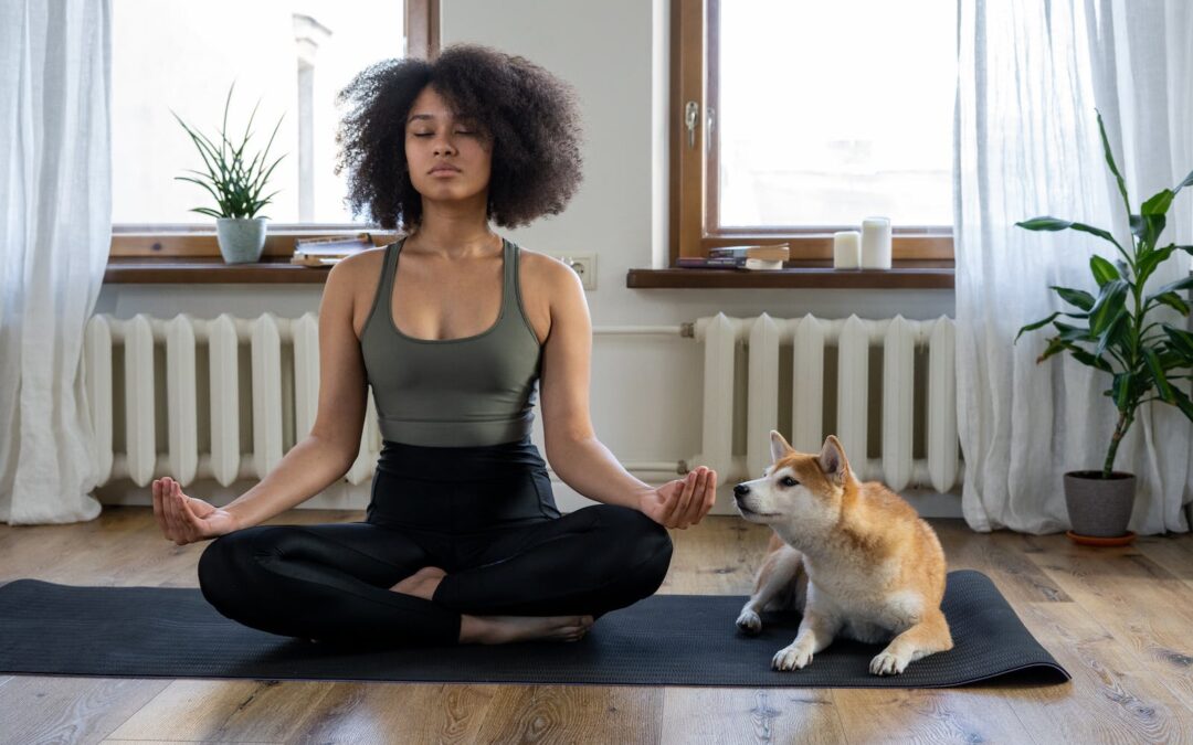 Woman Doing Yoga Beside her Dog